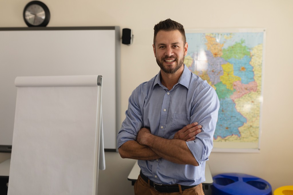 man in blue white and red plaid button up shirt wearing yellow hard hat holding black
